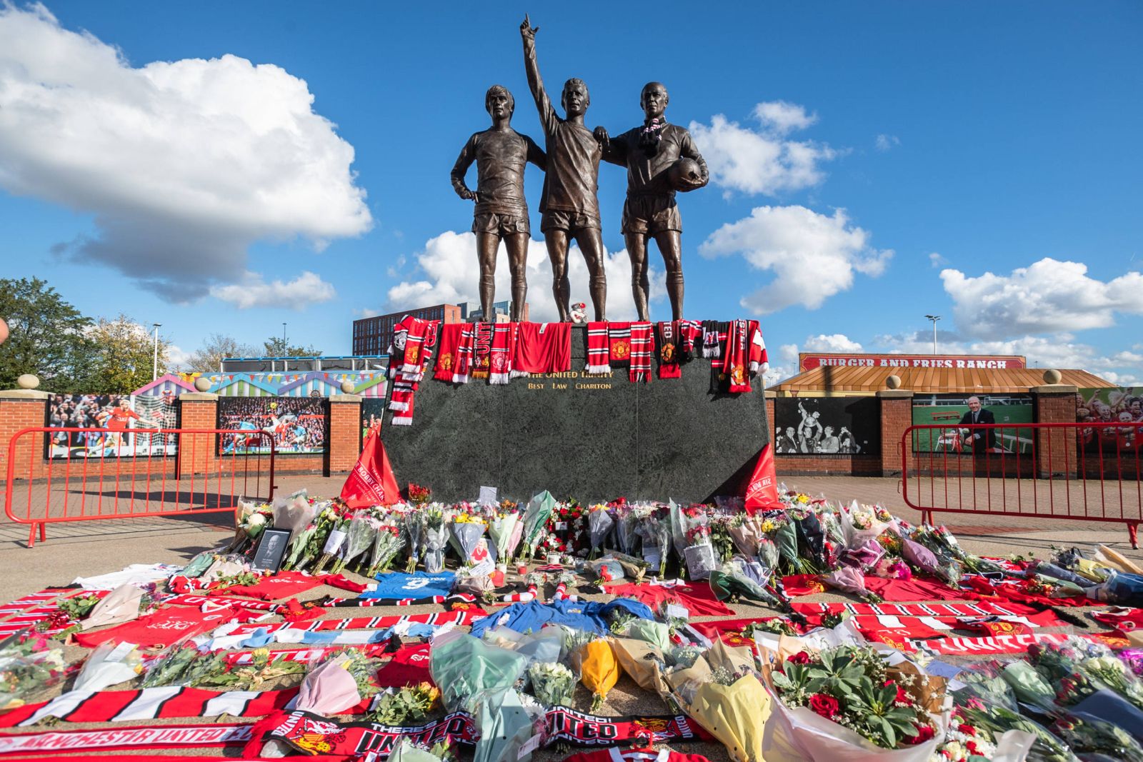 Floral tributes around the ÔUnited TrinityÕ statue outside Old Trafford football ground in Manchester on Sunday 22 October 2023. Fans have gathered following the announcement of the death of former Manchester United player Sir Bobby Charlton on Saturday. Charlton, who passed peacefully in the early hours of Saturday morning after being diagnosed with dementia in 2020, lifted three league titles, an FA Cup and a European Cup in a distinguished 17-year career at Old Trafford. He also scored 49 goals in 106 appearances for the Three Lions, famously helping them win the World Cup in 1966. Manchester Greater Manchesrer England Old Trafford PUBLICATIONxNOTxINxUK Copyright: xMattxWilkinsonx