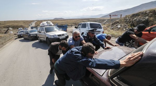 epa10893788 (FILE) - People help to move a broken car as ethnic Armenians fleeing Nagorno-Karabakh region make their way near the village of Kornidzor, Armenia, 28 September 2023. (Issued 01 October 2023). The self-declared Republic of Nagorno-Karabakh, is a territory mostly home to ethnic Armenians that the Soviets allocated to Azerbaijan in 1921 and is recognized as Azerbaijani by the international community.  Some 120,000 ethnic Armenians of the enclave have, in September 2023, joined again the roads to exodus. Caught in the conflict  with Azerbaijan,  and after dozens of violence flares since the 1990's, they have repeatedly had to leave their lands and become displaced or refugees in the tens of thousands, losing over the years their homes and thousands of loved ones to direct fighting or to collateral damage.  After a ceasefire was agreed on, on 20 September 2023, Azerbaijan opened all the checkpoints with Armenia for the unimpeded exit of civilians from the disputed territory. The Armenian government announced the evacuation of more than 96,000 local residents from Nagorno-Karabakh, and a humanitarian center has been set up near the main route between Armenia and the breakaway region. Nagorno-Karabakh will cease to exist as a self-proclaimed state from 01 January 2024, the region's separatist leader, Samvel Shakhramanyan, announced on 28 September, after signing a decree to dissolve all its institutions.  EPA/ANATOLY MALTSEV  ATTENTION: This Image is part of a PHOTO SET