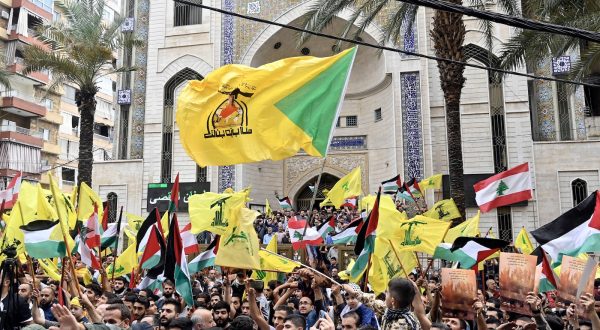 epa10907150 Supporters of Hezbollah wave Palestinian and Hezbollah flags during a rally to express solidarity with Palestinians in the Gaza Strip, in Beirut, Lebanon, 08 October 2023. Rocket barrages were launched from the Gaza Strip early 07 October in a surprise attack on Israel claimed by the Islamist movement Hamas.  EPA/WAEL HAMZEH