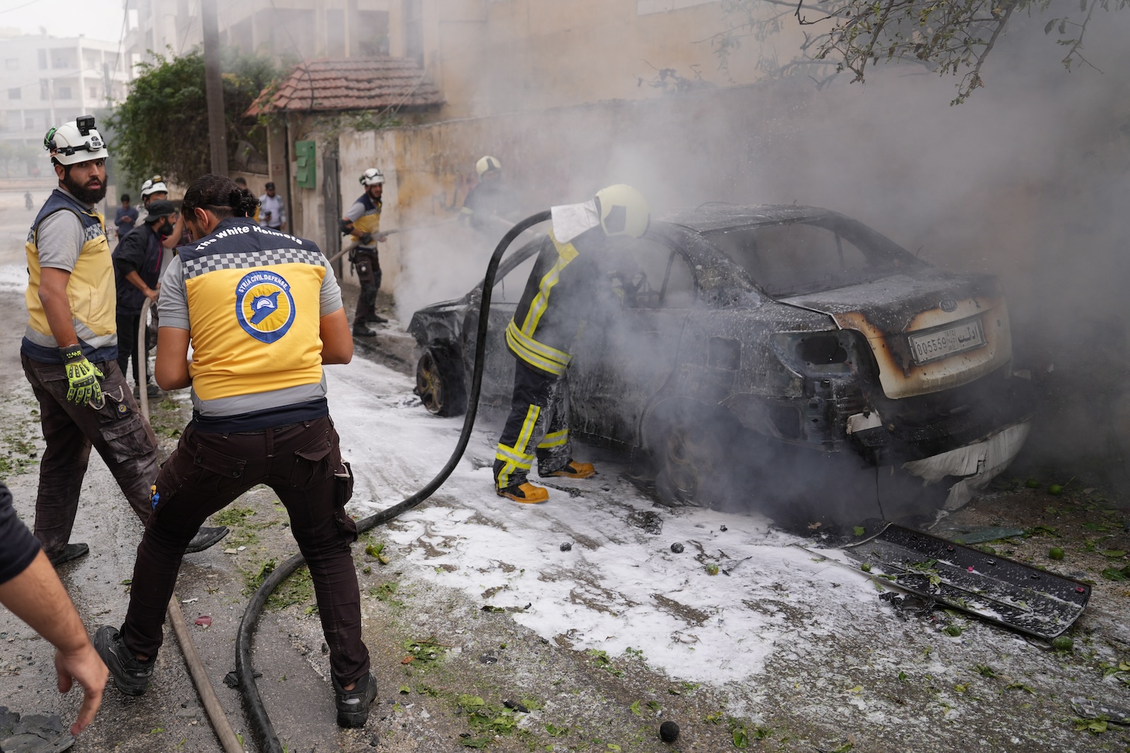 epa10907258 Members of the Syrian civil defense work at the site of an attack by Syrian forces against a neighborhood in Idlib, Syria, 08 October 2023. According to the UK-based Syrian Observatory for Human Rights (SOHR), at least four people were killed in a rocket strike reportedly carried by government forces on residential neighborhoods in the center of Idlib city. According to the White Helmets, the Syria Civil Defence organization operating in northwestern Syria, the death toll of attacks targeting opposition-controlled Aleppo countryside and Idlib since 05 October increased to at least 41 people.  EPA/YAHYA NEMAH