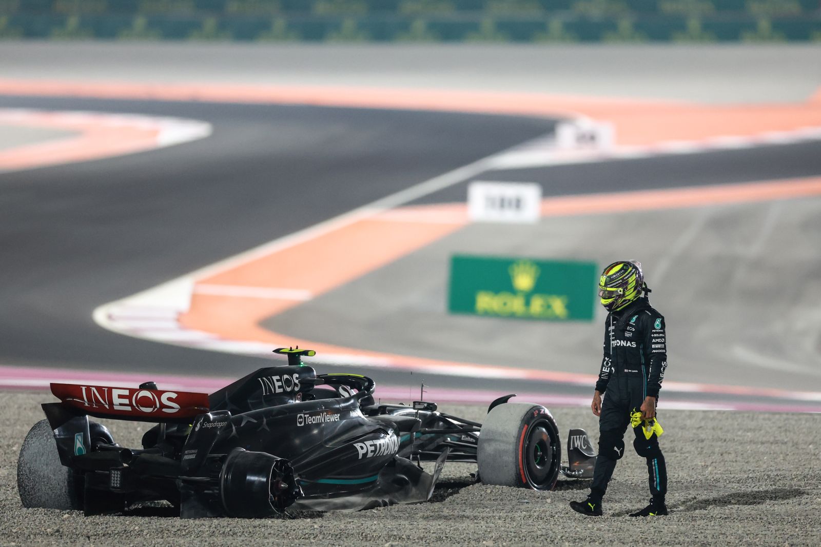 epa10908128 British Formula One driver Lewis Hamilton of Mercedes-AMG Petronas stands next to his car after crashing in turn 1 after the start of the Formula 1 Qatar Grand Prix in Lusail, Qatar, 08 October 2023.  EPA/ALI HAIDER