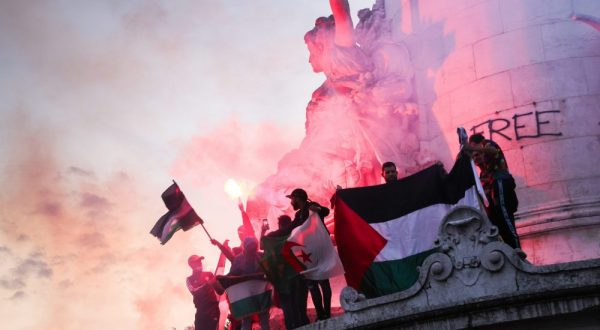epaselect epa10915420 A dozen young people climb the statue with the flags of different arab countries at the banned demonstration in support of the Palestinian people on Republic Square in Paris, France, 12 October 2023. Several hundred people took part in the vigil that had been banned by the police prefecture on 11 October. Thousands of Israelis and Palestinians have been killed since the militant group Hamas launched an unprecedented attack on Israel from the Gaza Strip on October 7, 2023, prompting Israeli retaliatory strikes against the Palestinian enclave.  EPA/TERESA SUAREZ