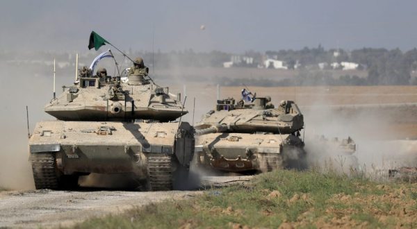 epa10916243 IDF 'Merkava' battle tanks maneuver at an area along the border with Gaza, southern Israel, 13 October 2023. The Israel Defense Forces (IDF) on 13 October called for the evacuation of all civilians of Gaza City from their homes southwards 'for their own safety and protection' and to move south of the Wadi Gaza, warning that in the following days Israeli military operations will take place in the Palestinian city. More than 1,300 Israelis have been killed and over 3,200 others injured, according to the IDF, after the Islamist movement Hamas launched an attack against Israel from the Gaza Strip on 07 October. More than 1,500 Palestinians have been killed and over 6,600 others injured in Gaza since Israel launched retaliatory air strikes, Palestinian health officials said.  EPA/ATEF SAFADI