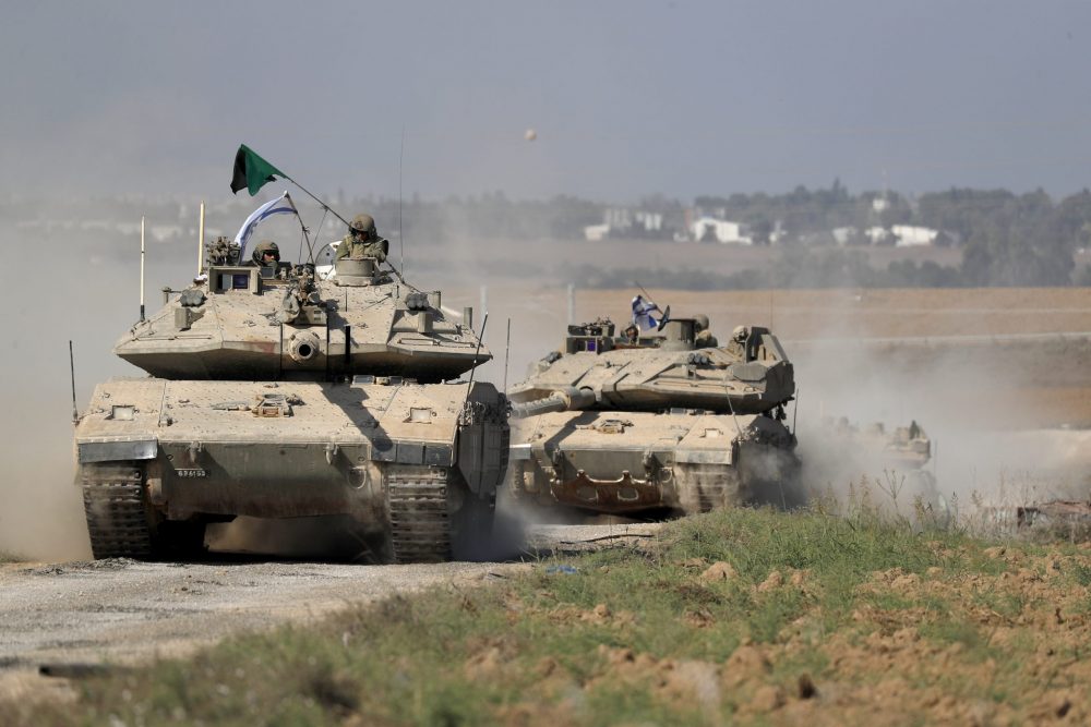 epa10916243 IDF 'Merkava' battle tanks maneuver at an area along the border with Gaza, southern Israel, 13 October 2023. The Israel Defense Forces (IDF) on 13 October called for the evacuation of all civilians of Gaza City from their homes southwards 'for their own safety and protection' and to move south of the Wadi Gaza, warning that in the following days Israeli military operations will take place in the Palestinian city. More than 1,300 Israelis have been killed and over 3,200 others injured, according to the IDF, after the Islamist movement Hamas launched an attack against Israel from the Gaza Strip on 07 October. More than 1,500 Palestinians have been killed and over 6,600 others injured in Gaza since Israel launched retaliatory air strikes, Palestinian health officials said.  EPA/ATEF SAFADI