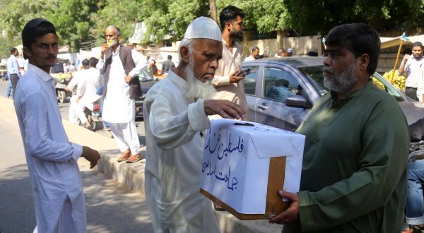 epa10916995 Workers of Islamic political party Jamat-e-Islami collect donations for the Palestinian people, in Karachi, Pakistan, 13 October 2023. Thousands of Israelis and Palestinians have died since the militant group Hamas launched an unprecedented attack on Israel from the Gaza Strip on 07 October 2023, leading to Israeli retaliation strikes on the Palestinian enclave.  EPA/REHAN KHAN