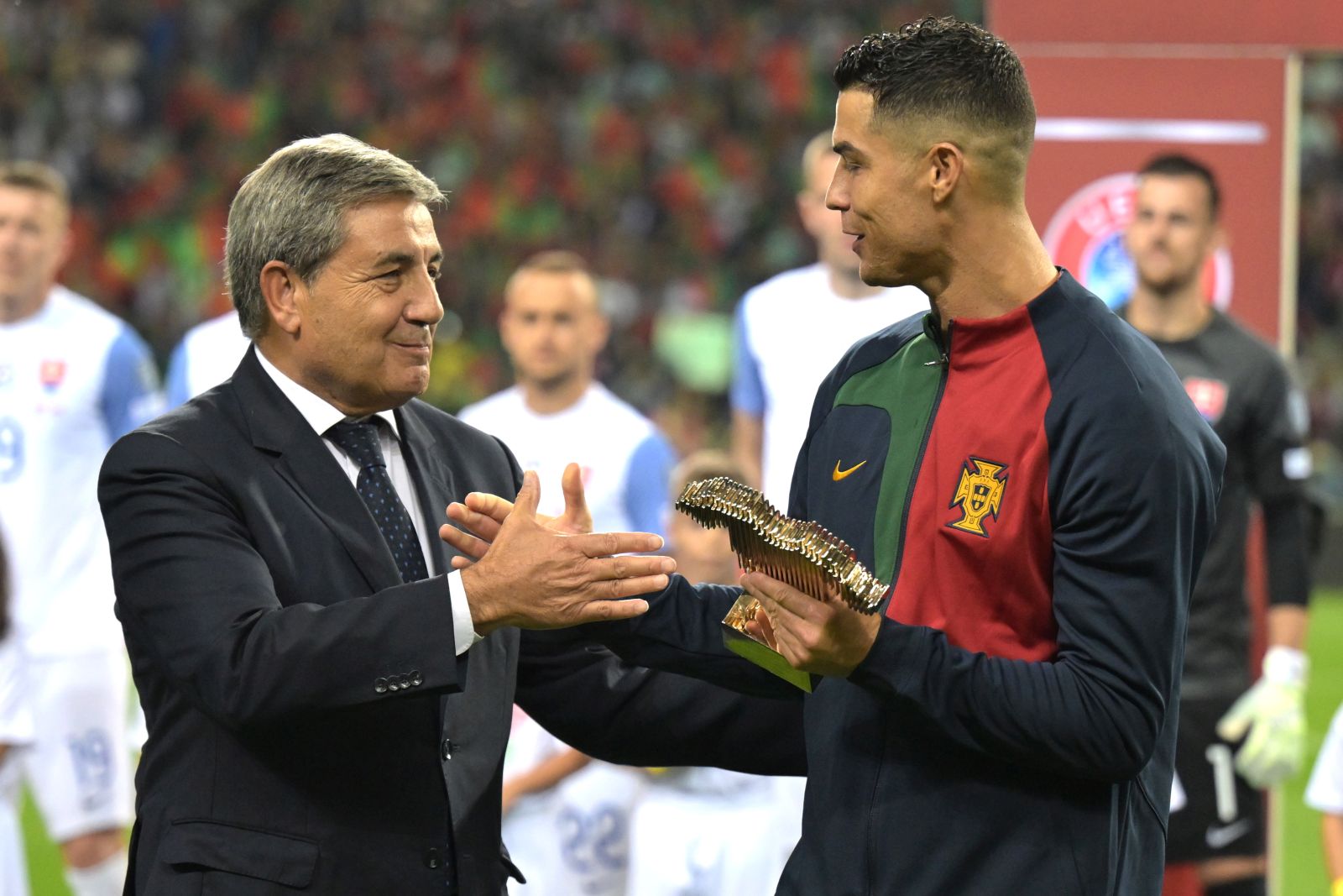 epa10917617 Portugal's Cristiano Ronaldo (R) receives an award for his 200 matches with the Portugese national team from Fernando Gomes, president of the Portuguese Soccer Federation, ahead of the UEFA EURO 2024 group J qualifying soccer match between Portugal and Slovakia, in Porto, Portugal, 13 October 2023.  EPA/FERNANDO VELUDO