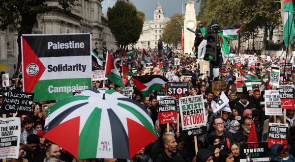 epa10930801 Pro-Palestinian protesters hold placards and show Palestinian colors on a march through the British capital during a demonstration for the Palestinian people, in London, Britain, 21 October 2023. Thousands of Israelis and Palestinians have died since the militant group Hamas launched an unprecedented attack on Israel from the Gaza Strip on 07 October 2023, and the Israeli strikes on the Palestinian enclave which followed it.  EPA/ANDY RAIN