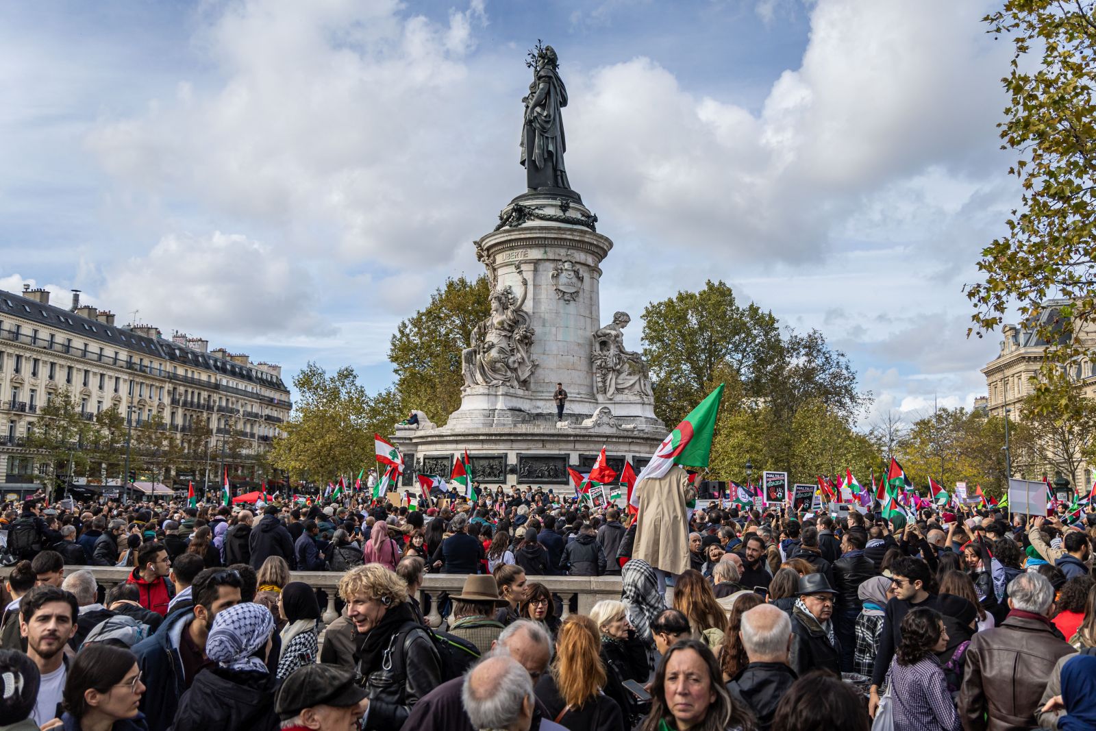 epa10932991 Protesters hold Palestinian flags during a demonstration to support Palestine, at the Place de la Republique in Paris, France, 22 October 2023. Thousands of Israelis and Palestinians have died since the militant group Hamas launched an unprecedented attack on Israel from the Gaza Strip on 07 October, and the Israeli strikes on the Palestinian enclave which followed it.  EPA/CHRISTOPHE PETIT TESSON