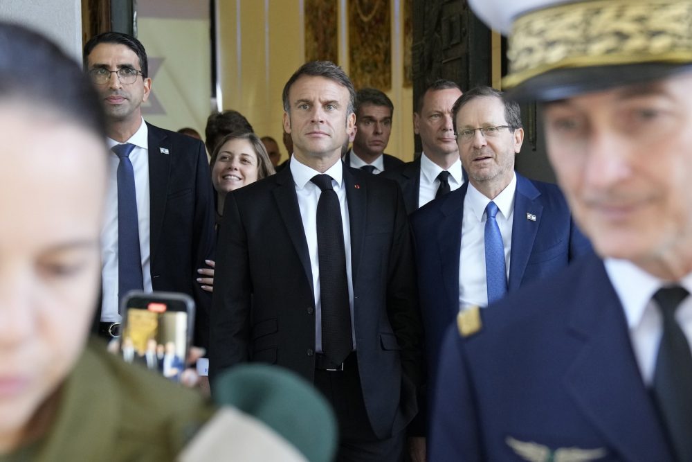 epa10935414 French President Emmanuel Macron (C-L) and Israel's President Isaac Herzog leave after their talks in Jerusalem, 24 October 2023. Macron is traveling to Israel to show France's solidarity with the country and further work on the release of hostages who are being held in Gaza.  EPA/CHRISTOPHE ENA / POOL MAXPPP OUT