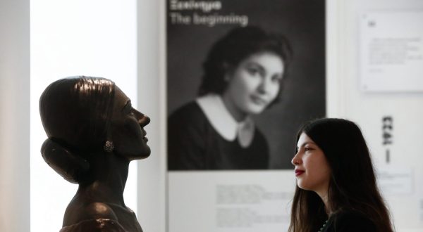 epa10938133 A woman poses for a picture as she looks at a portrait bust of the late soprano Maria Callas during a press view of the new Maria Callas museum in Athens, Greece, 25 October 2023. Callas was an American-born Greek soprano and one of the most famous opera singers of the 20th century.  EPA/YANNIS KOLESIDIS