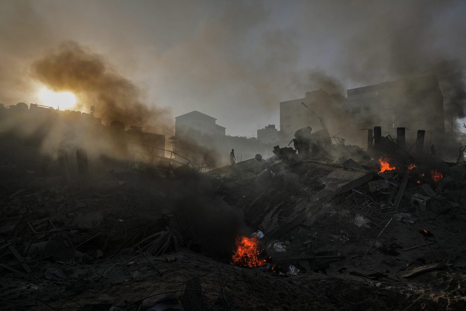 epa10938645 Smoke rises from the rubble of a destroyed area following Israeli air strikes in Gaza City, 25 October 2023. More than 5,500 Palestinians and over 1,400 Israelis have been killed, according to the Israel Defense Forces (IDF) and the Palestinian health authority, since Hamas militants launched an attack against Israel from the Gaza Strip on 07 October, and the Israeli operations in Gaza and the West Bank that followed it.  EPA/MOHAMMED SABER