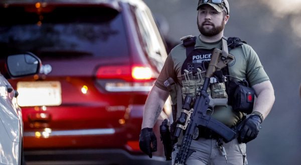 epa10941782 A Heavily armed law enforcement officer is seen near the home of mass-shooting suspect Robert Card in Bowdoin, Maine, USA, 26 October 2023. Police are searching for suspect Robert Card following a mass shooting which killed 18 and injured 13 in nearby Lewiston, Maine, on 25 October 2023.  EPA/CJ GUNTHER