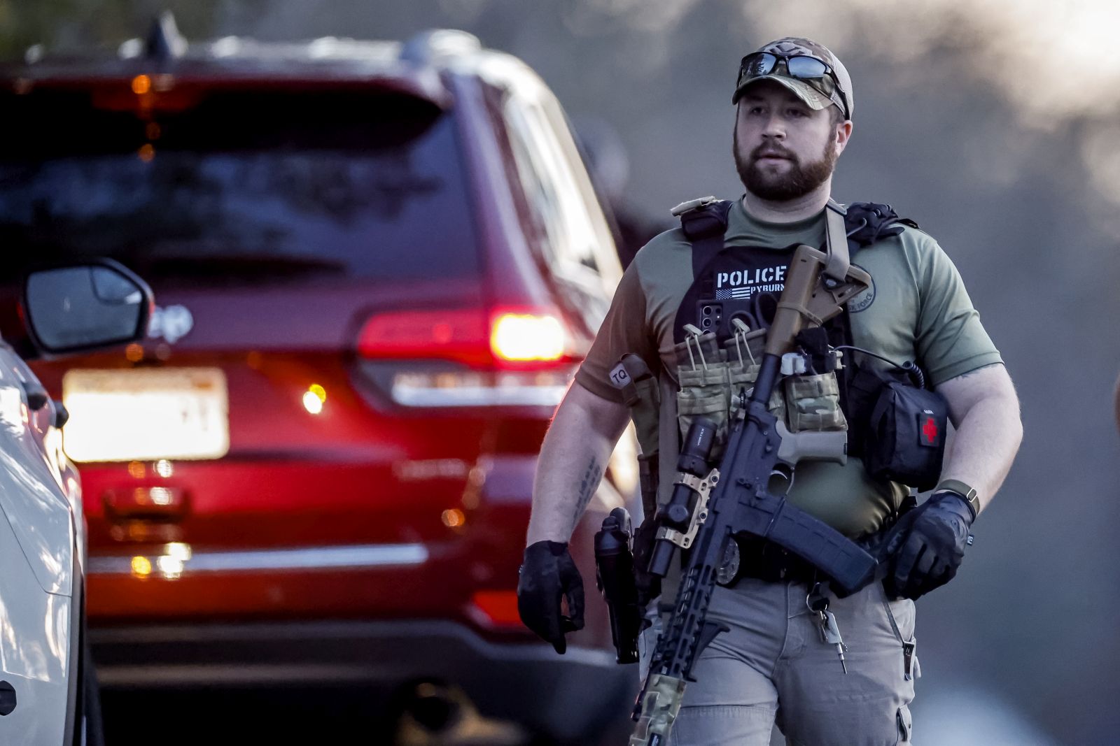 epa10941782 A Heavily armed law enforcement officer is seen near the home of mass-shooting suspect Robert Card in Bowdoin, Maine, USA, 26 October 2023. Police are searching for suspect Robert Card following a mass shooting which killed 18 and injured 13 in nearby Lewiston, Maine, on 25 October 2023.  EPA/CJ GUNTHER