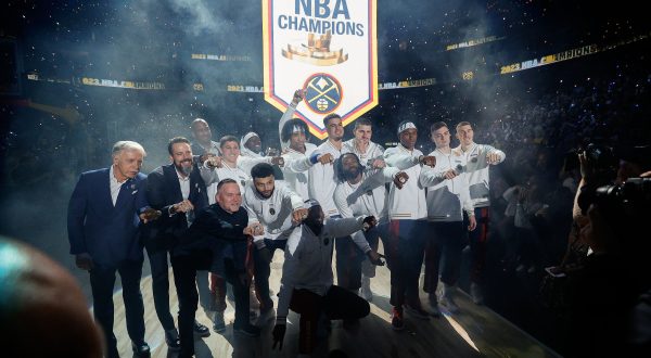 Oct 24, 2023; Denver, Colorado, USA; Denver Nuggets players and team personnel pose for a picture as their NBA Championship banner is lifted into the rafters before the game against the Los Angeles Lakers at Ball Arena. Mandatory Credit: Isaiah J. Downing-USA TODAY Sports Photo: Isaiah J. Downing/REUTERS