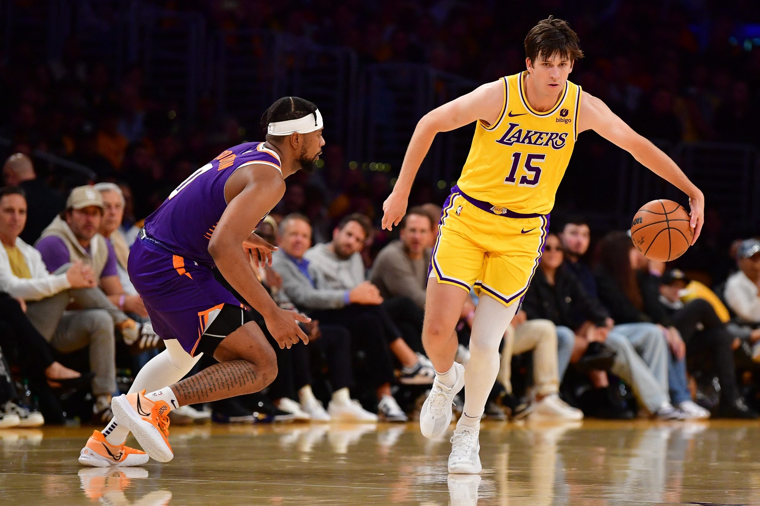 Oct 26, 2023; Los Angeles, California, USA; Los Angeles Lakers guard Austin Reaves (15) moves the ball against Phoenix Suns guard Jordan Goodwin (0) during the second half at Crypto.com Arena. Mandatory Credit: Gary A. Vasquez-USA TODAY Sports Photo: Gary A. Vasquez/REUTERS
