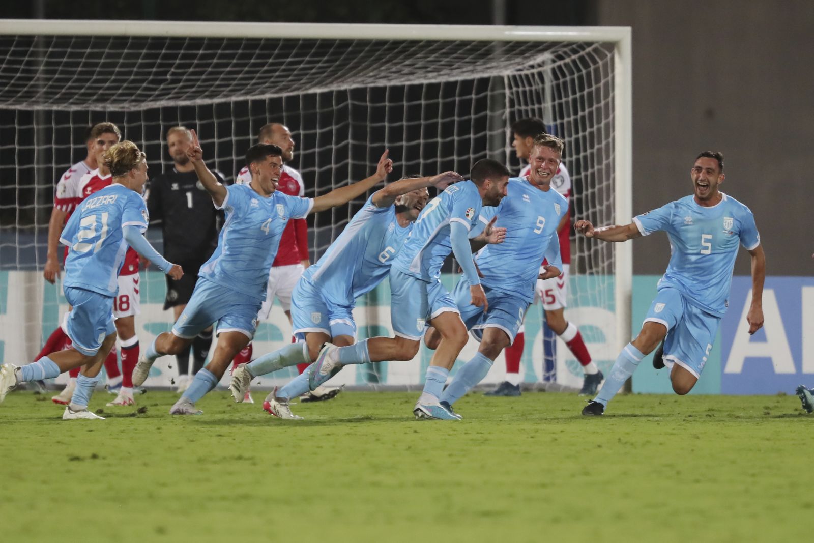 San Marino's Alessandro Golinucci, fourth from right, celebrates with his teammates after scoring his side's opening goal during the Euro 2024 group H qualifying soccer match between San Marino and Denmark at the San Marino Stadium in Serravalle, San Marino, Tuesday, Oct. 17, 2023. (AP Photo/Felice Calabro)