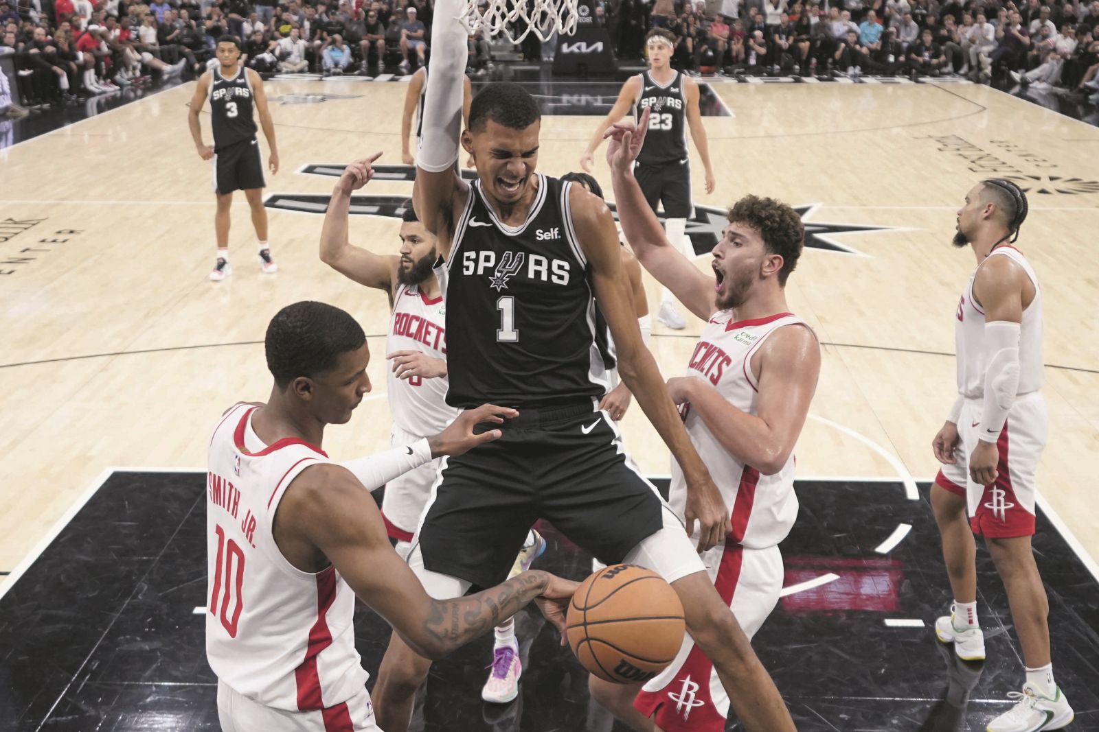 San Antonio Spurs center Victor Wembanyama (1) reacts to a play during overtime of the team's NBA basketball game against the Houston Rockets in San Antonio, Friday, Oct. 27, 2023. (AP Photo/Eric Gay)