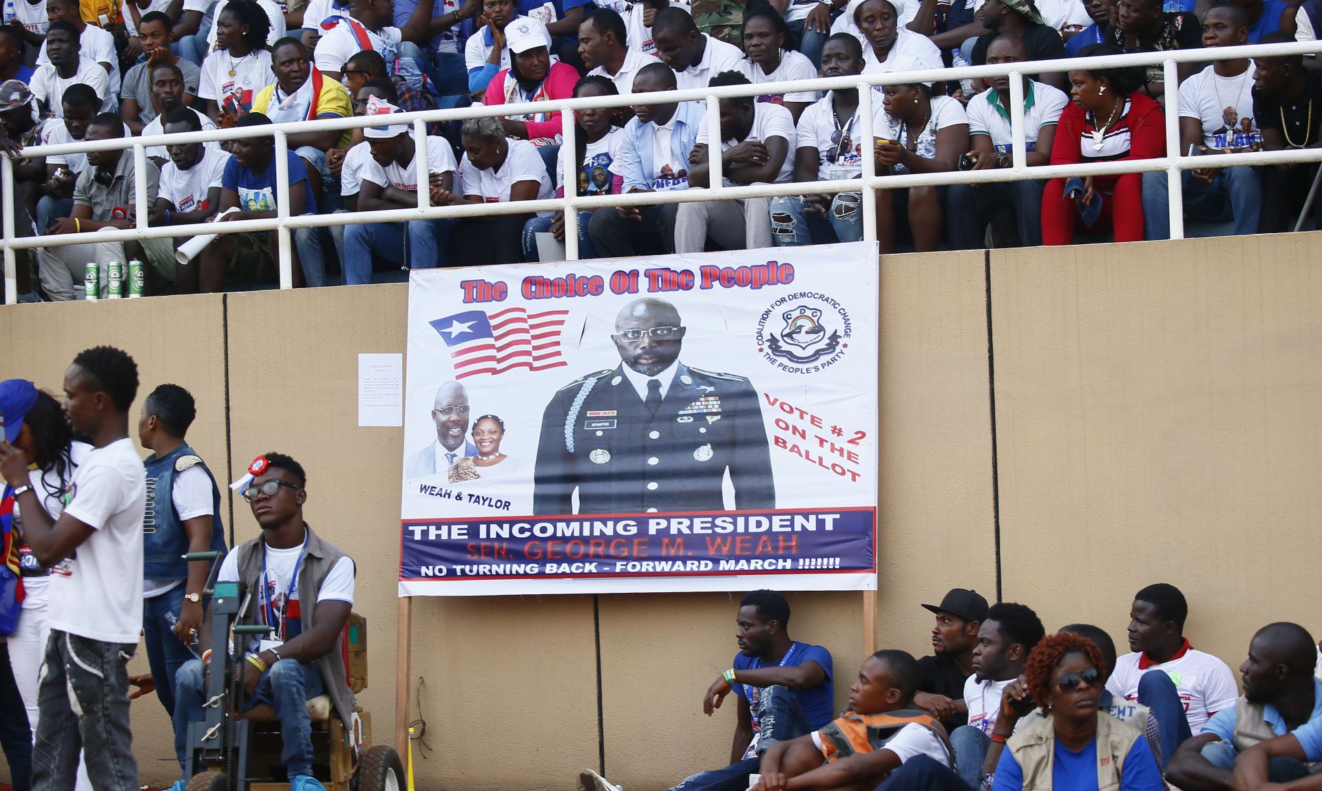 epa06404394 Campaign poster of  George Weah, presidential candidate  the opposition  Coalition for  Democratic Change (CDC),  cheers during closing   of campaigns  at the Samuel Kanyon Doe Sports Complex in Monrovia,  Liberia, 23 December 2017. Liberians go to the polls on 26 December, in  run-off presidential elections to choose between George Weah, presidential candidate of the Coalition for Democratic Change (CDC), and Joseph Nyuma Boakai, presidential candidate and incumbent vice president, representing the governing Unity party (UP) to succeed Ellen Johnson Sirleaf, who  concludes her second and final term of office.  EPA/AHMED JALLANZO