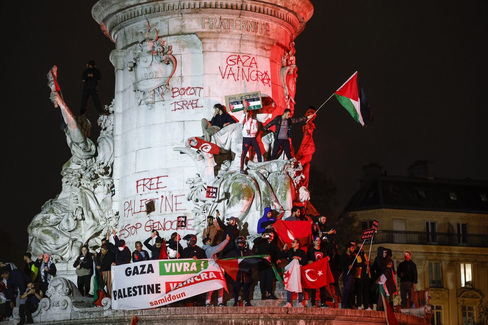 epa10927806 People with Palestine flags shout slogans at the 'Place de la Republique' during a demonstration to support the Palestinian people, in Paris, France, 19 October 2023. Thousands of Israelis and Palestinians have died since the militant group Hamas launched an unprecedented attack on Israel from the Gaza Strip on 07 October 2023, leading to Israeli strikes on the Palestinian enclave.  EPA/YOAN VALAT