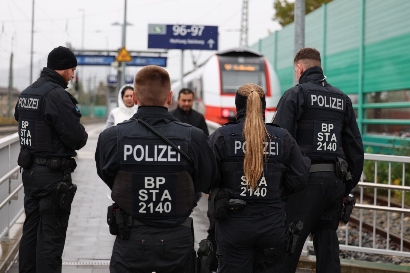 epa10935773 German police officers check passengers arriving by train from Austria at a border crossing point between Germany and Austria in Freilassing, Germany, 24 October 2023. Austria and Germany have introduced temporary border controls to stem irregular migration. German Federal Police has apprehended 1,550 smuggling operations and around 1,700 smugglers across Germany so far this year, and has detected around 98,000 unauthorised entries into Germany, the federal interior ministry said. According to the authorities, smugglers repeatedly put refugees' lives danger during smuggling operations, for example during unsecured transport on loading platforms or in airtight lorries. On 13 October, seven people were killed, including a six-year-old child, in a serious traffic accident involving an overcrowded smuggling vehicle on the A94 motorway in Bavaria.  EPA/Anna Szilagyi