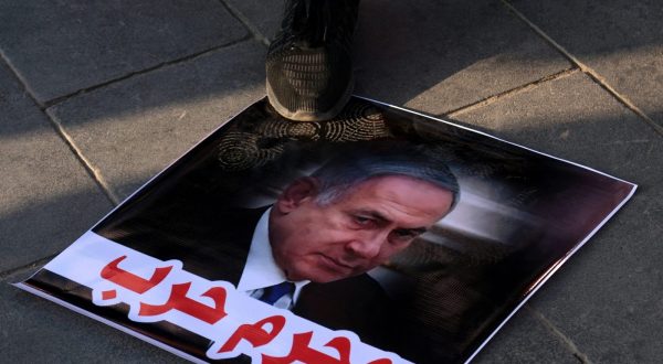epa10943223 An Iraqi protester steps over a picture of Israel's Prime Minister Benjamin Netanyahu with a slogan reading in Arabic 'war criminal' during a pro-Palestinians rally, at Tahrir square in central Baghdad, Iraq, 27 October 2023. More than 7,000 Palestinians and at least 1,300 Israelis have been killed, according to the Israel Defense Forces (IDF) and the Palestinian health authority, since Hamas militants launched an attack against Israel from the Gaza Strip on 07 October, and the Israeli operations in Gaza and the West Bank which followed it.  EPA/AHMED JALIL