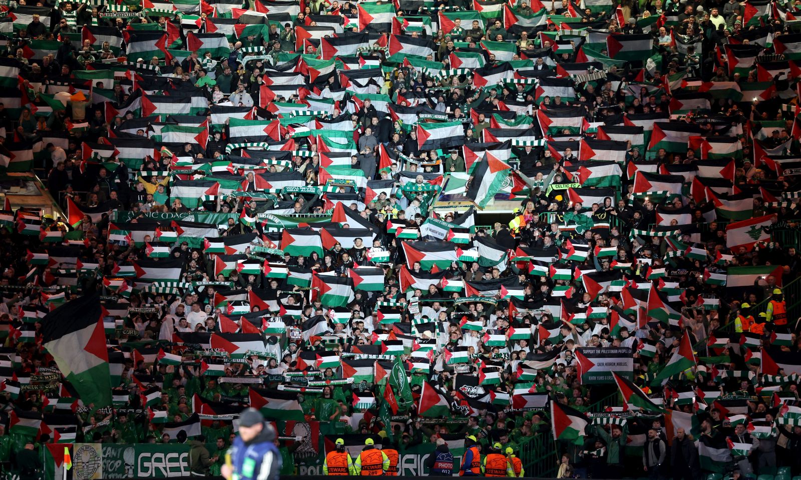 epa10939019 Supporters of Celtic wave Palestinian flags before the UEFA Champions League Group E match between Celtic Glasgow and Atletico Madrid in Glasgow, Britain, 25 October 2023.  EPA/ROBERT PERRY