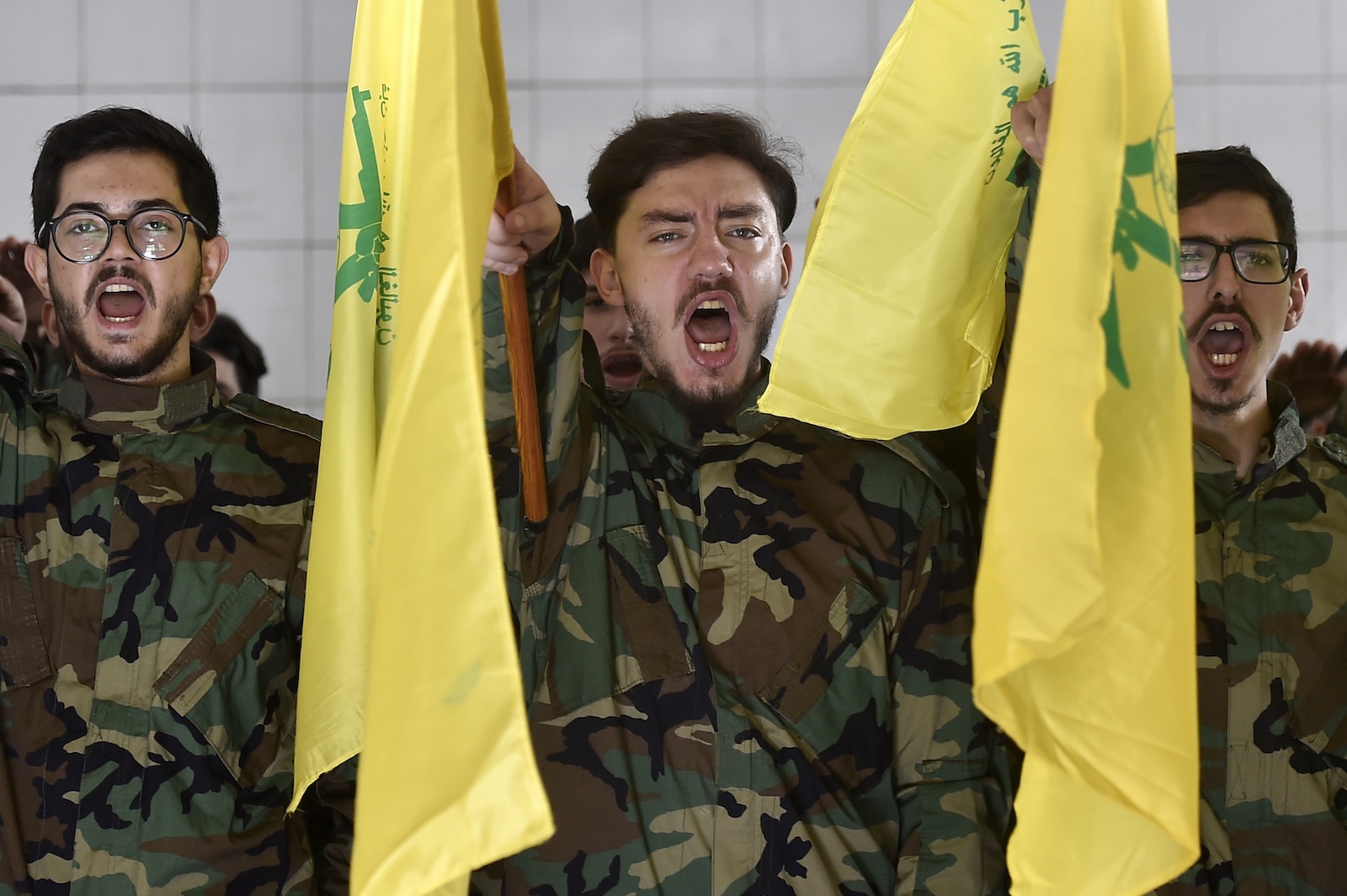 epa10960383 Hezbollah militants shout slogans during the funeral of Hezbollah fighter Qasim Ibrahim Abu Taam, who was killed a previous day in southern Lebanon, in the southern suburb of Beirut, Lebanon, 06 November 2023. Tensions remain high at the border between Israel and Lebanon after the Israeli-Palestinian conflict escalated following an unprecedented attack carried out by Hamas militants from Gaza into Israel on 07 October 2023.  EPA/WAEL HAMZEH