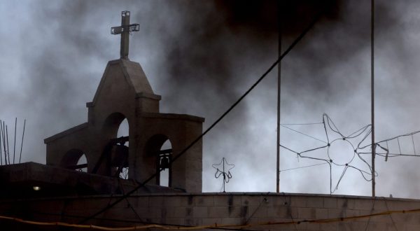 epaselect epa10966319 Black smoke rises over the Jenin church during clashes between Palestinians and Israeli troops following an Israeli raid at the Jenin refugee camp, in the West Bank city of Jenin, 09 November 2023. According to the Palestinian Health Ministry, at least nine Palestinians were killed and around 15 others were injured during heavy clashes with Israeli troops. Since 07 October 2023, more than 160 Palestinians have been killed, while over 2,000 have sustained injuries in the West Bank.  EPA/ALAA BADARNEH