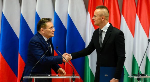 epa10974546 CEO of the Russian State Atomic Energy Corporation Rosatom, Alexey Likhachev (L) and Hungarian Minister of Foreign Affairs and Trade Peter Szijjarto shake hands during a press conference after they signed a construction schedule plan for 2024 in Paks, central Hungary, 14 November 2023. Szijjarto said that two new reactor blocks will start operating in the early 2030s. The investment aims to increase the capacity of Hungary's only nuclear plant, which already has four reactors that were built between 1982 and 1987. The plant, situated near the town of Paks, currently generates about half of the country's electricity. Rosatom is in charge of the Paks II project, which began in early 2014 by an agreement between governments to build two more reactors at the Paks nuclear factory, both provided by Rosatom.  EPA/TAMAS VASVARI HUNGARY OUT