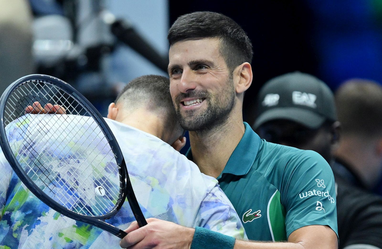 epa10978707 Novak Djokovic (R) of Serbia celebrates after winning his round robin match against Hubert Hurkacz (L) of Poland at the Nitto ATP Finals tennis tournament in Turin, Italy, 16 November 2023.  EPA/Alessandro Di Marco