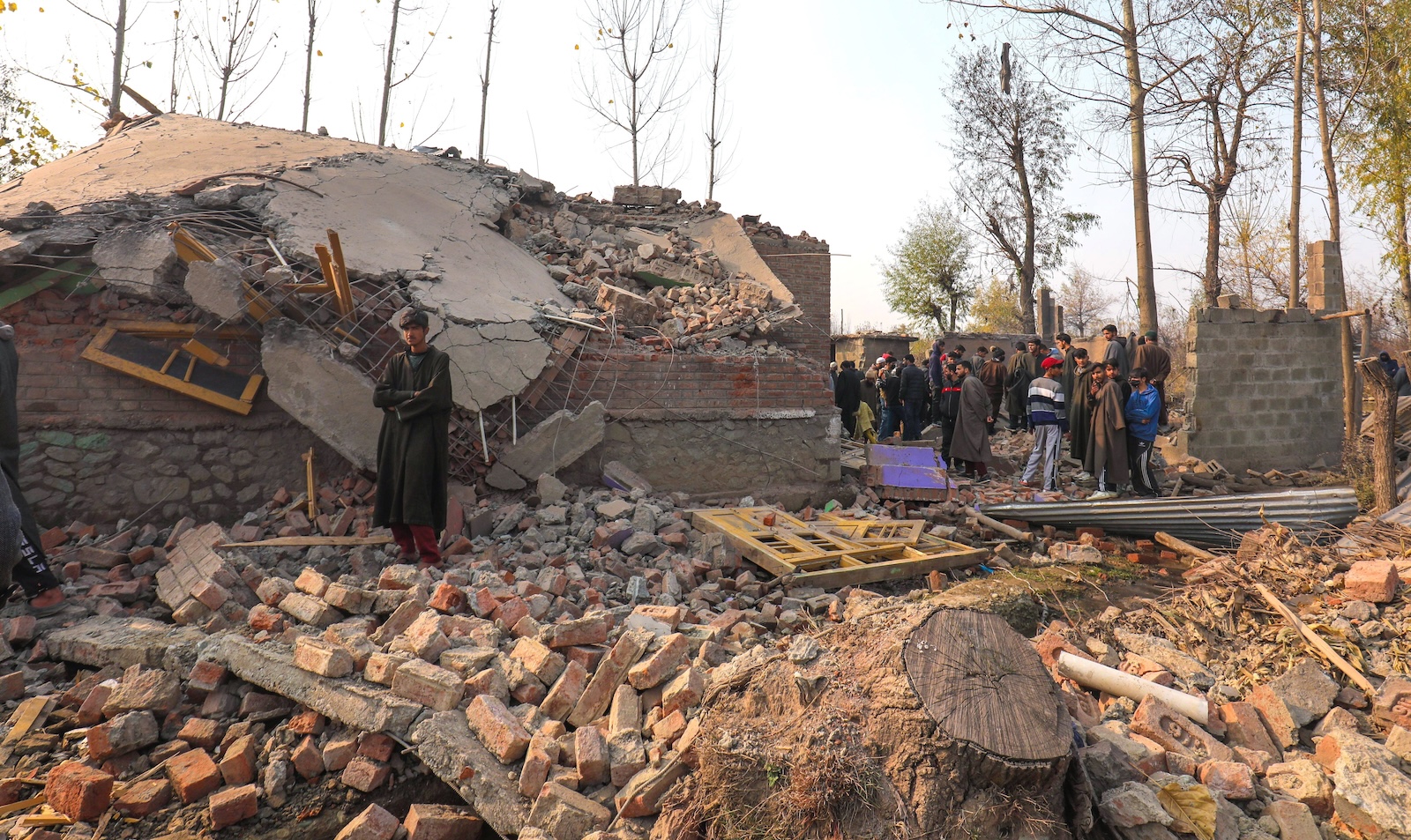 epa10980591 Kashmiri villagers look at houses damaged during a gunfight in in south Kashmirâ€™s Kulgam district some 80 kilometers from Srinagar, the summer capital of Indian Kashmir, 17 November 2023. Five militants were killed and two residential houses were damaged during a gunfight between Indian security forces and miltants in Kulgam.  EPA/FAROOQ KHAN 	34848