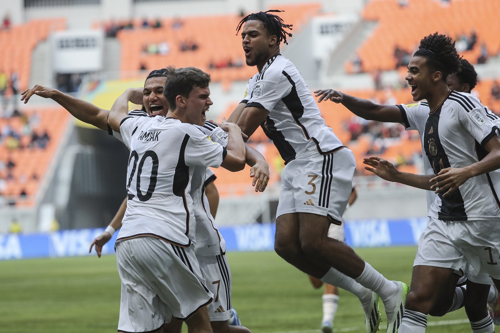 epa10982063 Robert Ramsak of Germany (L) celebrates with his team mates after scoring the opening goal during the FIFA U-17 World Cup group stage match between Germany and Venezuela at the Jakarta International Stadium in Jakarta, Indonesia, 18 November 2023.  EPA/BAGUS INDAHONO
