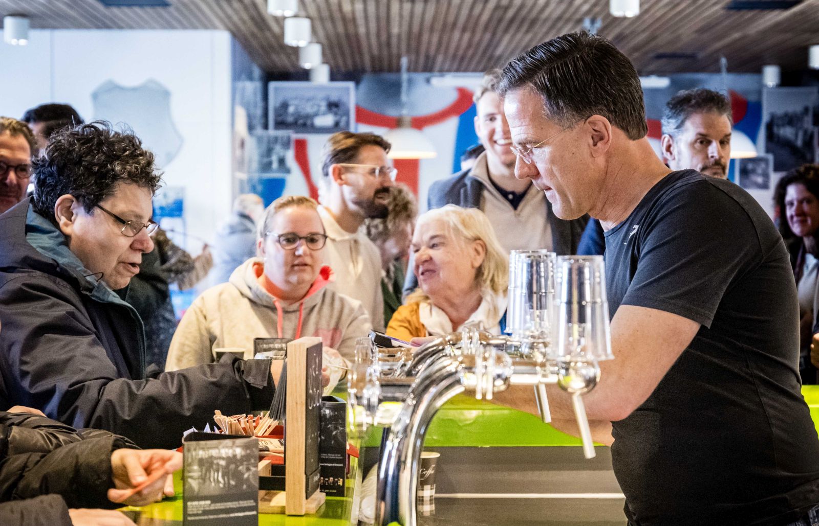 epa10984591 Former political leader of the People's Party for Freedom and Democracy (VVD), Dutch Prime Minister Mark Rutte stands behind the bar of football club RKVV Jeka as part of the VVD election campaign in Bavel, Netherlands, 19 November 2023. The Netherlands is preparing for the House of Representatives elections on 22 November.  EPA/ROB ENGELAAR