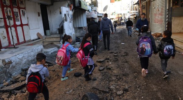 epa10987619 Palestinian school children move along a damaged street  after an Isareli army operation at Balta refugee camp, near Nablus, West Bank, 21  November 2023. According to the Palestinian Red Crescent, nine people were injured in the operation. More than 12,000 Palestinians and at least 1,200 Israelis have been killed, according to the Israel Defense Forces (IDF) and the Palestinian health authority, since Hamas militants launched an attack against Israel from the Gaza Strip on 07 October, and the Israeli operations in Gaza and the West Bank which followed it.  EPA/ALAA BADARNEH