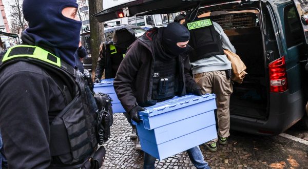 epa10990557 Police officers carry evidence during a raid on suspected Hamas and Samidoun properties, in Berlin, Germany, 23 November 2023. A total of 15 properties were searched on the morning of 23 November in connection with a ban on the Palestinian militant group Hamas and the pro-Palestinian group Samidoun, the German Interior Ministry announced. The searches were conducted in Berlin, Lower Saxony, North Rhine-Westphalia and Schleswig-Holstein. On 02 November, the German government banned activities in Germany related to Hamas, a designated terrorist organization, and the international network 'Samidoun - Palestinian Solidarity Network'. The sub-organization 'Samidoun Deutschland' was banned and dissolved on the same day.  EPA/FILIP SINGER