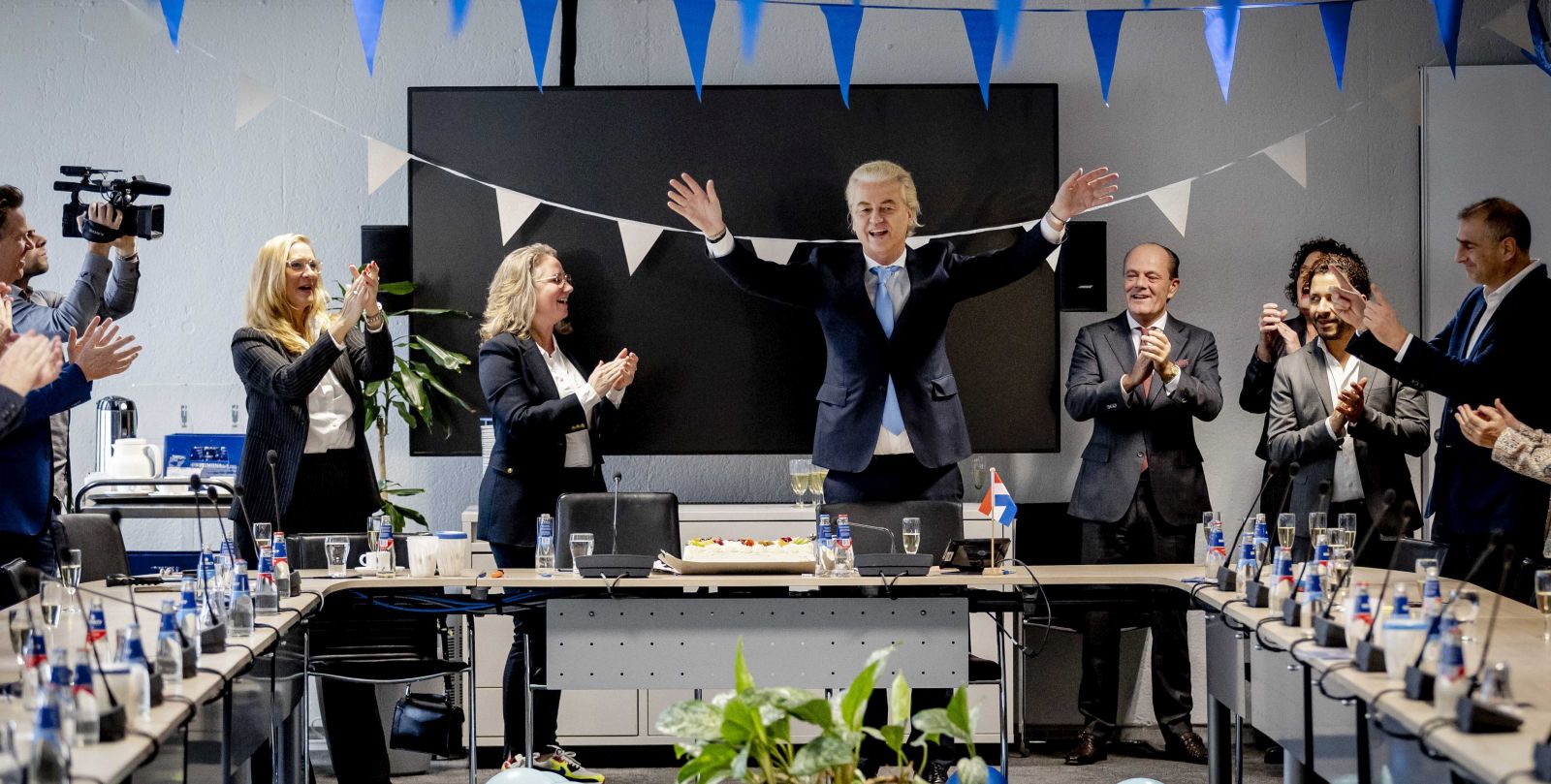 epa10990601 Leader of Freedom party (PVV) Geert Wilders (C-R) gestures next to Dutch MP Fleur Agema (C-L) one day after the House of Representatives elections, The Hague, Netherlands, 23 November 2023. Wilders believes that the PVV can no longer be ignored after the "mega victory" in the House of Representatives elections. He calls on other parties to work together and step over their own shadows. The PVV party is set to win the parliamentary elections with 37 seats after most votes were counted.  EPA/REMKO DE WAAL