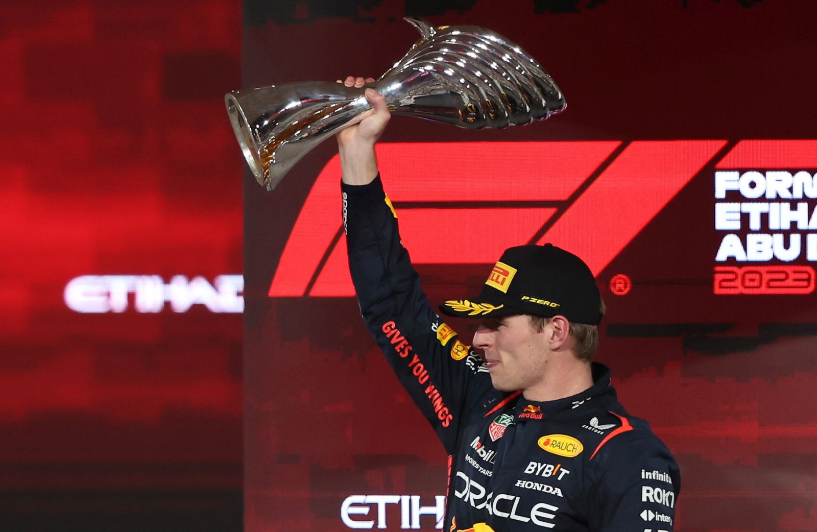 epa10996344 Dutch Formula One driver Max Verstappen of Red Bull Racing celebrates on the podium with his trophy after winning the Formula 1 Abu Dhabi Grand Prix in Abu Dhabi, United Arab Emirates, 26 November 2023.  EPA/ALI HAIDER