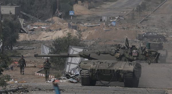 epa10996169 Israeli tanks move along Salah Al Din road in the central Gaza Strip, 26 November 2023. After Israel and Hamas agreed to a four-day ceasefire, mediated by Qatar, the US, and Egypt, that came into effect at 05:00 AM GMT on 24 November, some Palestinians who were still in central Gaza moved towards the south while others already displaced in the south went back to the northern part to check on relatives they had left behind and on their homes to collect salvageable belongings. As part of the ceasefire, the agreement included that 50 Israeli hostages, women and children, are to be released by Hamas. 150 Palestinian women and children that were detained in Israeli prisons are to be released in exchange.  EPA/MOHAMMED SABER