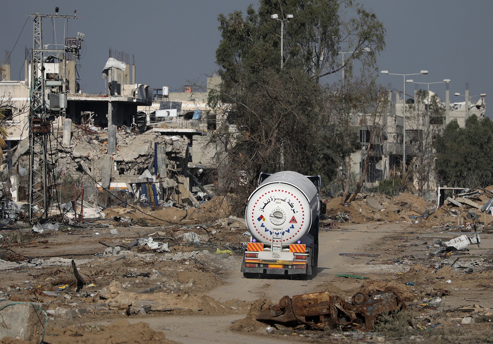 epa11001323 A fuel truck crosses from the southern Gaza Strip into the northern Gaza Strip along Salah Al Din road, in the central Gaza Strip, 29 November 2023. The four-day ceasefire agreed upon by Israel and Hamas was extended by 48 hours on 27 November, followed by more talks about a possible further extension. The Israeli army on 29 November has reissued its daily message to the residents of Gaza to avoid moving back into northern Gaza which is considered a “war zone", to not approach within one kilometer of the border and to not access the sea.  EPA/MOHAMMED SABER