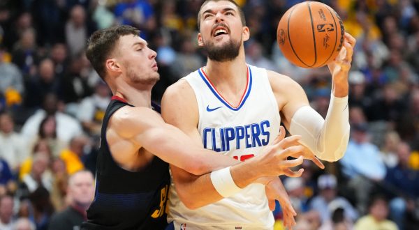Nov 14, 2023; Denver, Colorado, USA; Denver Nuggets guard Christian Braun (0) fouls LA Clippers center Ivica Zubac (40) in the second quarter at Ball Arena. Mandatory Credit: Ron Chenoy-USA TODAY Sports Photo: Ron Chenoy/REUTERS