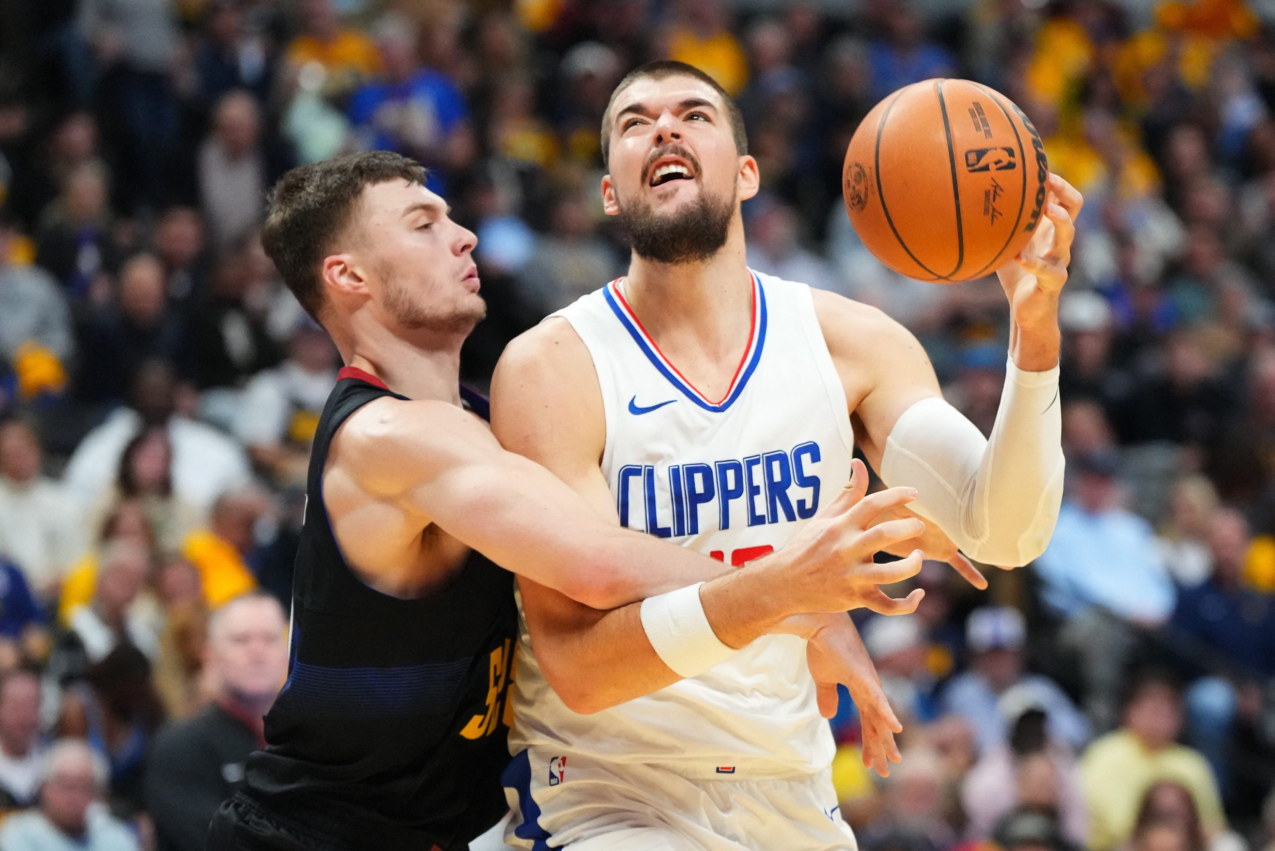 Nov 14, 2023; Denver, Colorado, USA; Denver Nuggets guard Christian Braun (0) fouls LA Clippers center Ivica Zubac (40) in the second quarter at Ball Arena. Mandatory Credit: Ron Chenoy-USA TODAY Sports Photo: Ron Chenoy/REUTERS