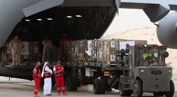 epa10984221 Volunteers from Qatari and Egypt’s Red Crescent humanitarian organizations unload aid destined for the Palestinians of the Gaza Strip at Egypt's Arish airport in the north Sinai, Egypt, 19 November 2023. According the UNRWA on 18 November,  "following long weeks of delay, Israeli Authorities approved only half of the daily minimum requirements of fuel for humanitarian operations in Gaza.", adding that it was far from enough to cover the needs of the displaced people and that "the last few days have seen a drastic reduction in these services including water availability and sewage clearance with serious consequences on people in need."  EPA/KHALED ELFIQI