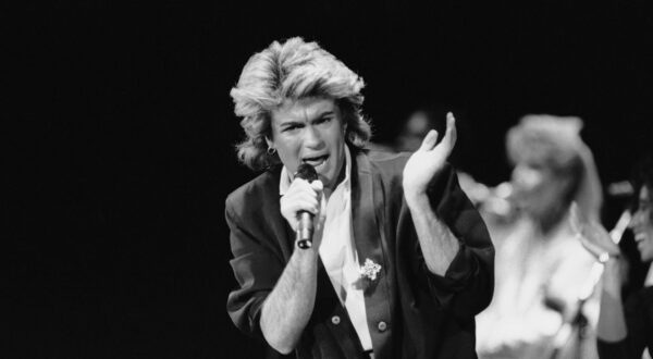 Wham! singer George Michael performs for a capacity crowd in Peking in China's first big-name rock concert, April 7, 1985. The group's music has been officially labeled "healthy" in China's changing society, where Western pop music was considered banal and filthy. (AP Photo/Neal Ulevich)