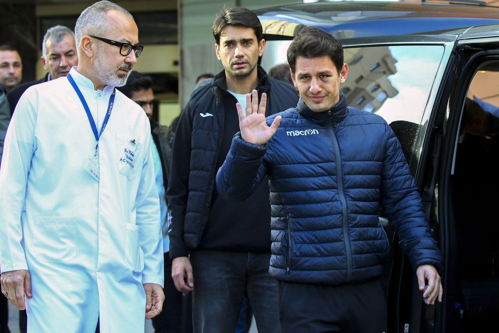 Turkish soccer referee Halil Umut Meler, right, gestures as he leaves Acibadem hospital in Ankara, Wednesday, Dec. 13, 2023. The Turkish Football Federation has suspended all league games after the president of a first-division soccer club punched a referee in the face at the end of a top-flight match. (AP Photo/Ali Unal)