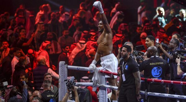 Anthony Joshua celebrates after defeating Otto Wallin in a boxing match at Kingdom Arena in Riyadh, Saudi Arabia, early Sunday, Dec. 24, 2023. (AP Photo)
