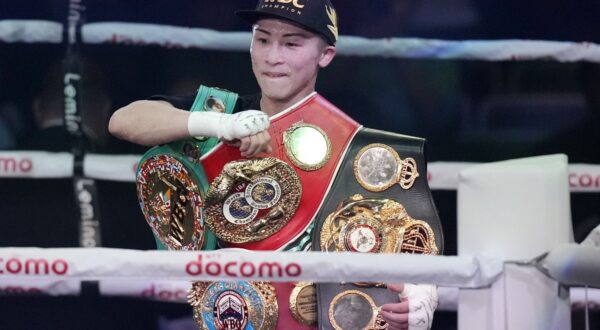 Naoya Inoue of Japan celebrates with his four champion belts, after defeating Marlon Tapales of the Philippines in the tenth round of their boxing match for the unified WBA, WBC, WBO and IBF super bantamweight world titles in Tokyo, Tuesday, Dec. 26, 2023. (AP Photo/Hiro Komae)