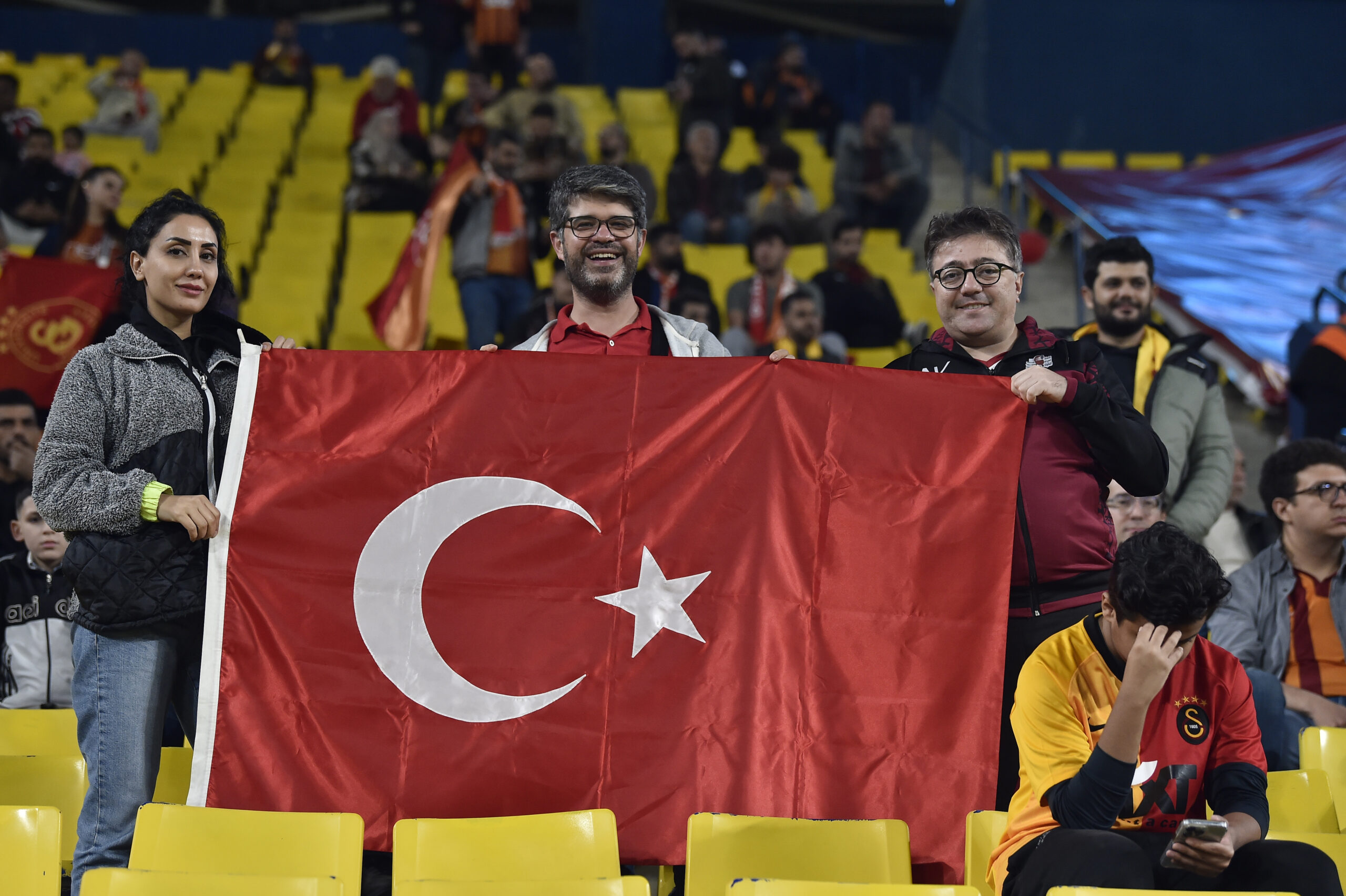 Turkish soccer fans wave their national flag as they wait for the Super Cup match between Galatasaray and Fenerbahce at Al Awal Park of King Saud University in Riyadh, Saudi Arabia, Friday, Dec. 29, 2023. (AP Photo)
