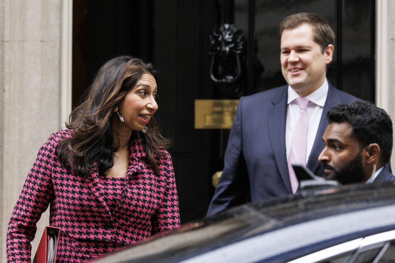 epa10935689 British Home Secretary Suella Braverman (L) and British Minister of State for Immigration Robert Jenrick leave Downing Street after a cabinet meeting in London, Britain, 24 October 2023. The UK Government is set to confirm some 50 hotel contracts to house migrants will be terminated by January 2024 in order to reduce the Â£8 million (EUR 9.2 million) a day cost for providing accommodation for housing asylum seekers.  EPA/TOLGA AKMEN