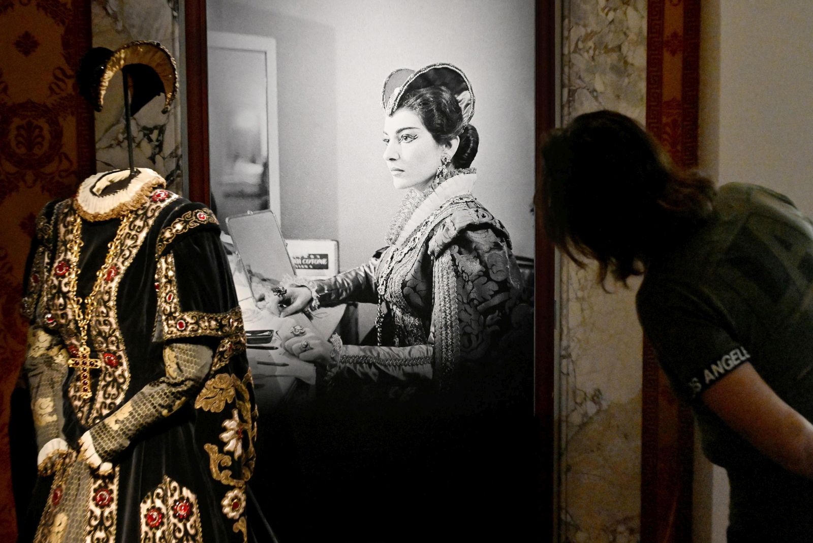 epa10978463 A visitor looks at installations in the 'Fantasmagoria Callas' exhibition set up in rooms of the Scala Theater Museum in Milan, Italy, 16 November 2023. The exhibition, that runs from 17 November to 24 April 2024, tells the story that Maria Callas left in the imagination of artists as Giorgio Armani, Alvin Curran, Francesco Vezzoli, Latifa Echakhch and Mario Martone.  EPA/Daniel Dal Zennaro
