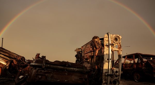 epa10997233 A rainbow over destroyed vehicles in the village of Posad-Pokrovske in the Kherson region, 01 November 2023. Russian troops entered Ukrainian territory in February 2022, starting a conflict that has provoked destruction and a humanitarian crisis.  EPA/OLEG PETRASYUK